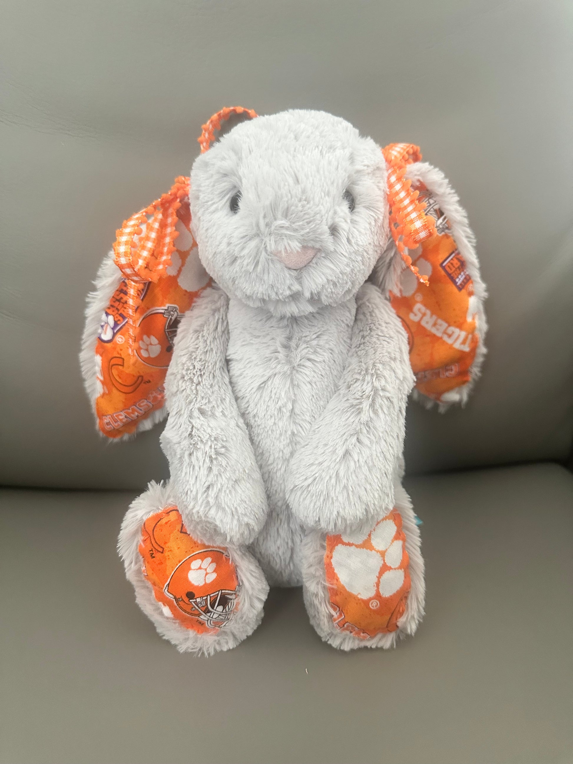 Gray Authentic Jellycat adorned with Clemson fabric and complimentary Orange and White Bows around the ears.