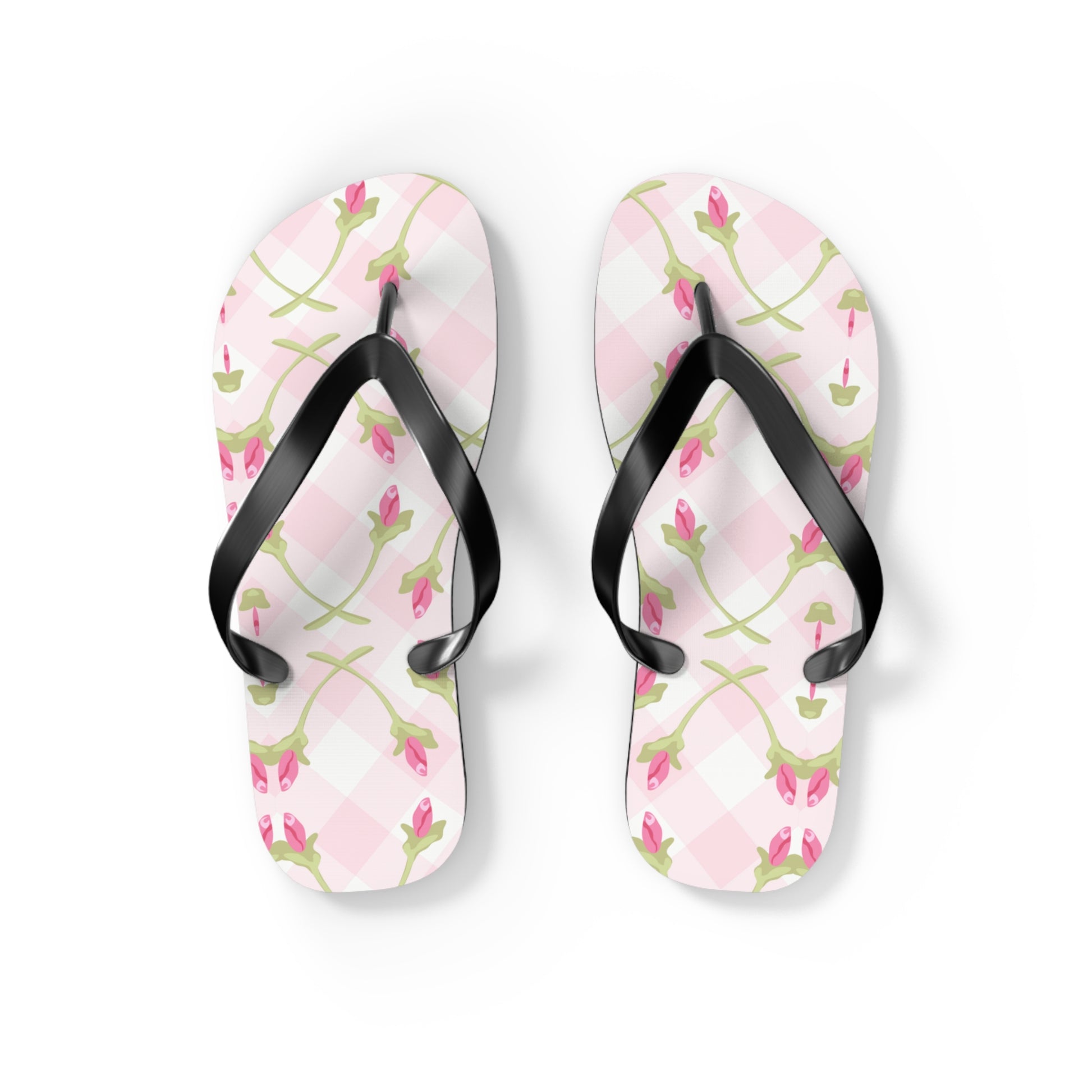 Floral patterned flip-flops with black straps on a white background