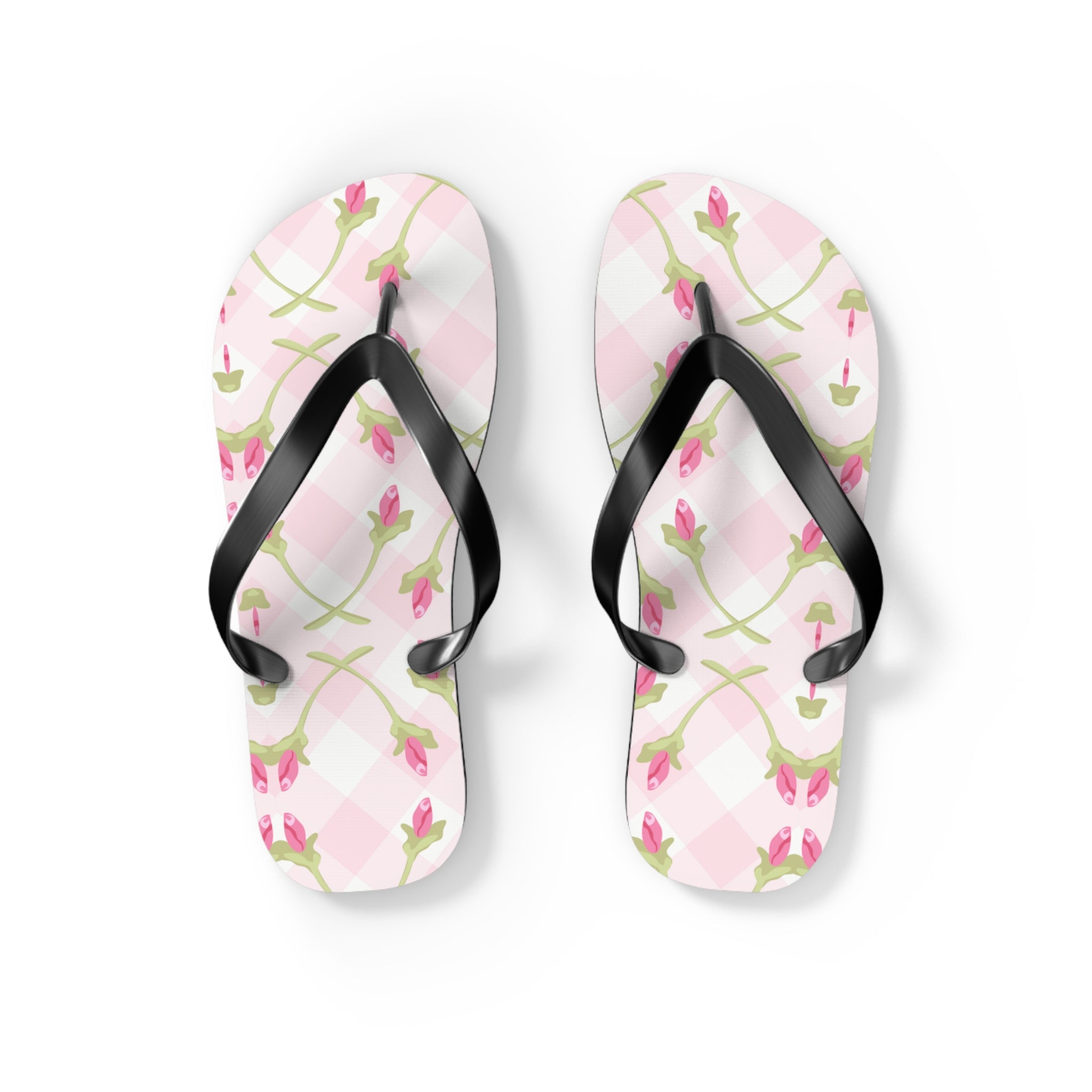 Floral patterned flip-flops with black straps on a white background