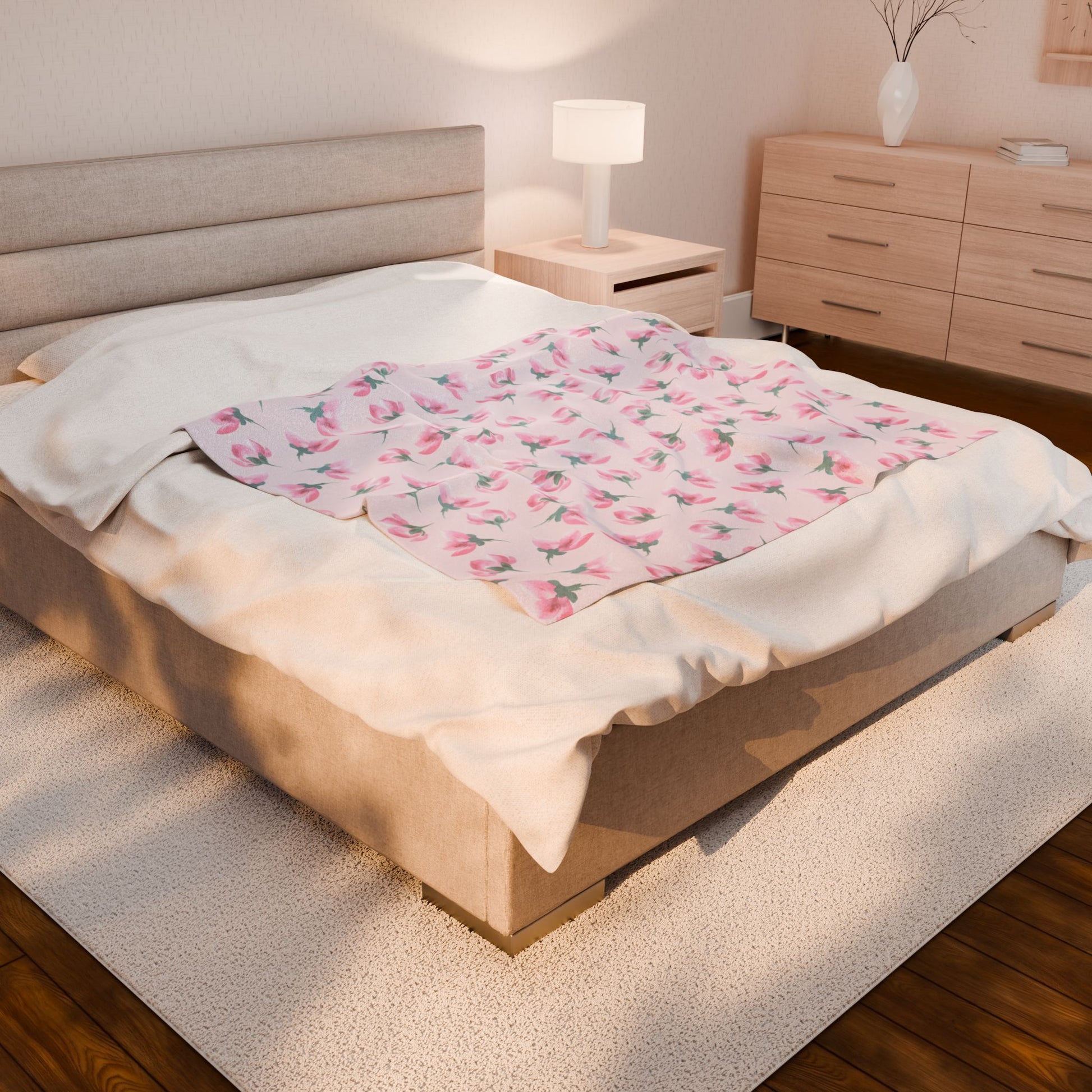 Bed with floral blanket and nightstand in a bedroom setting