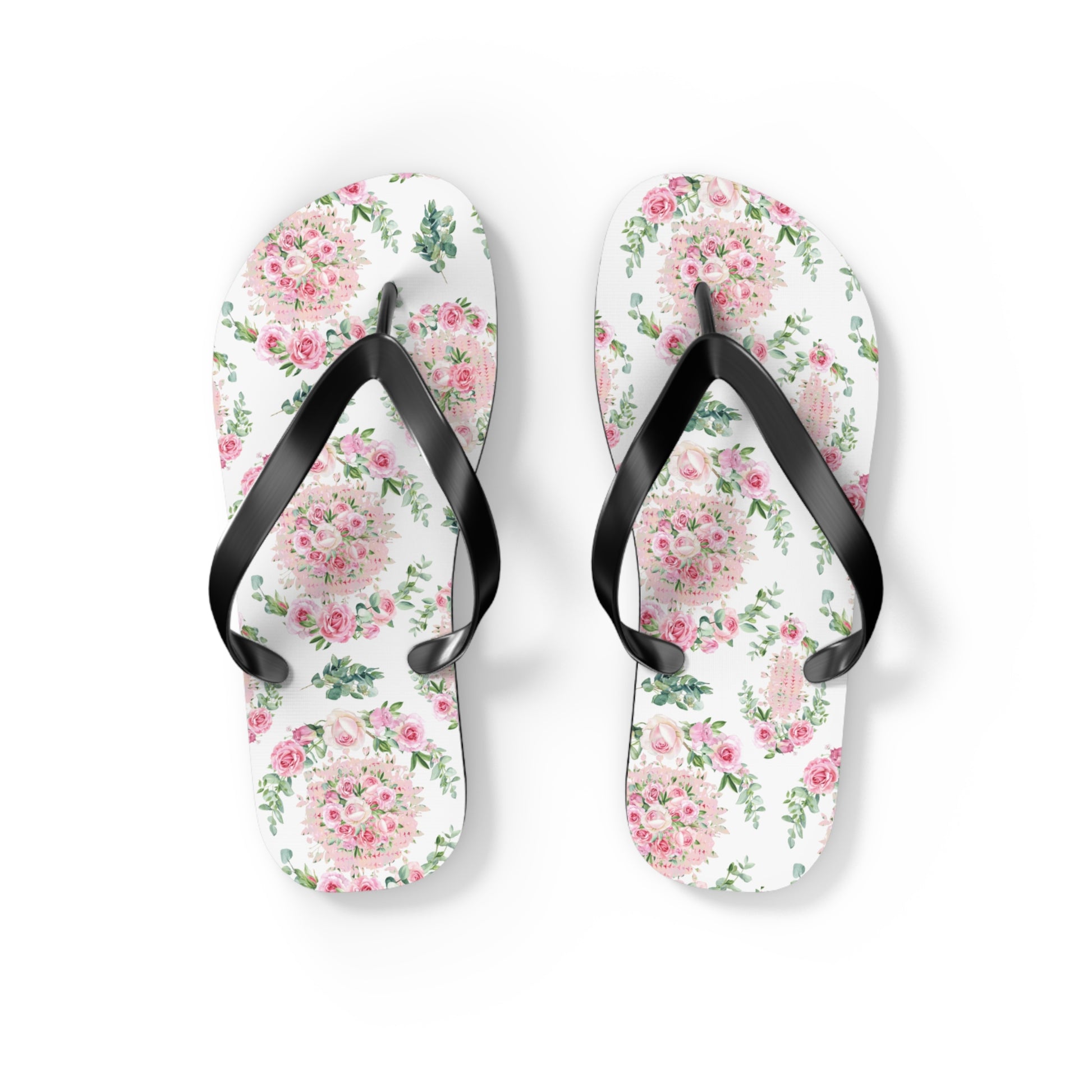 Floral patterned flip-flops with black straps on a white background