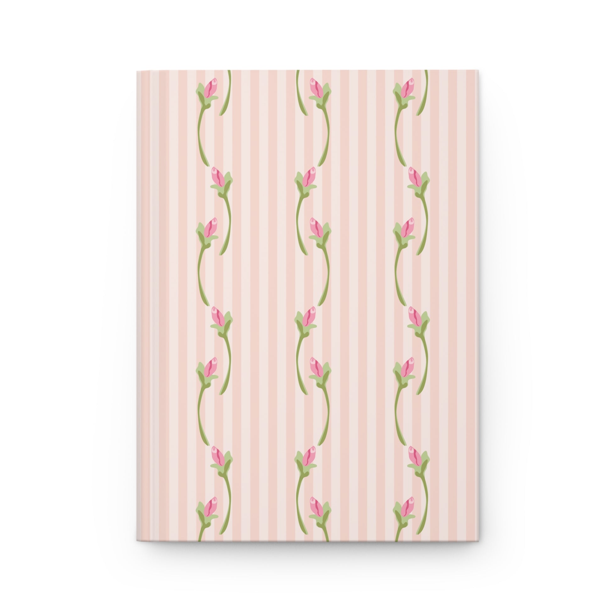Notebook with floral design on a pink striped background