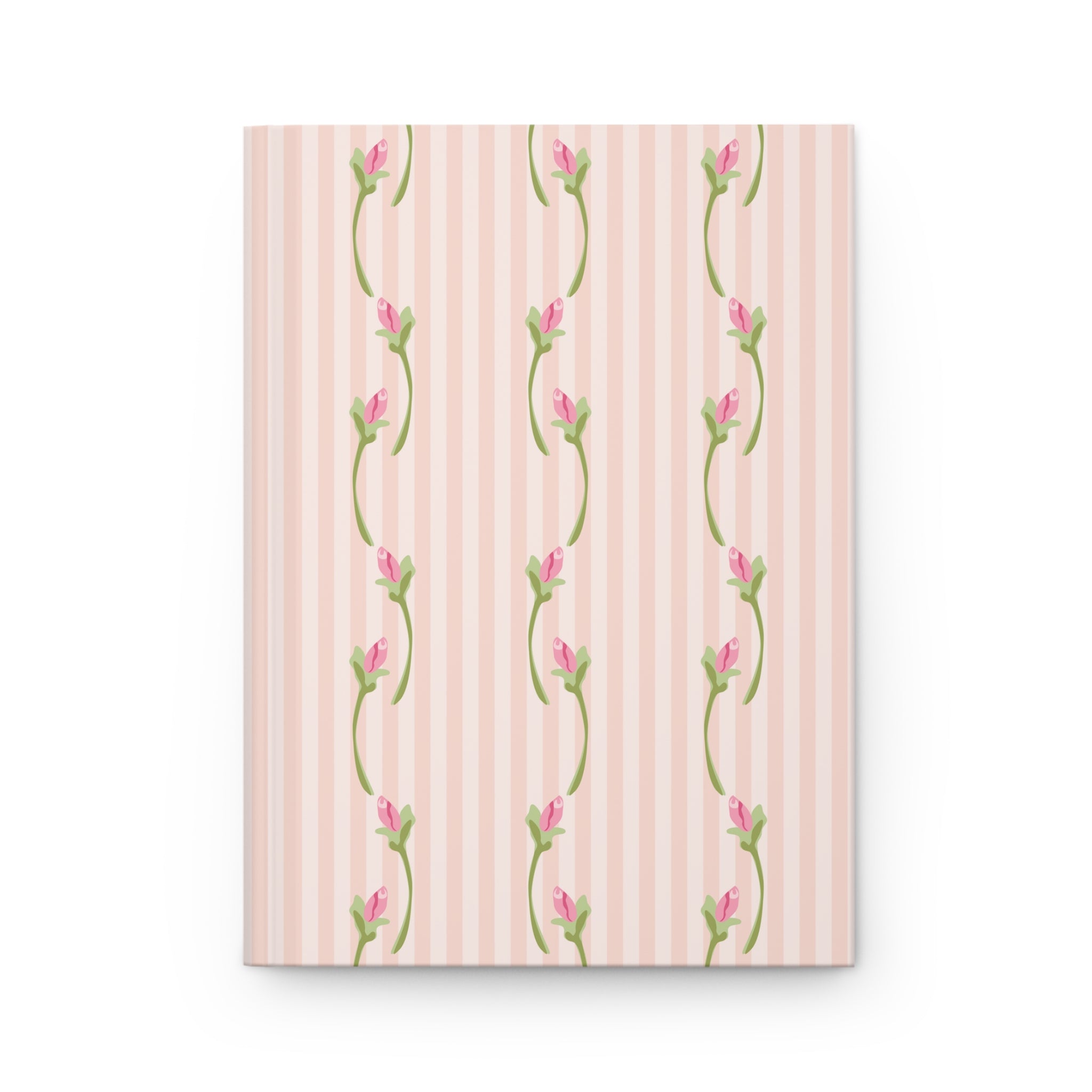 Notebook with floral design on a pink striped background