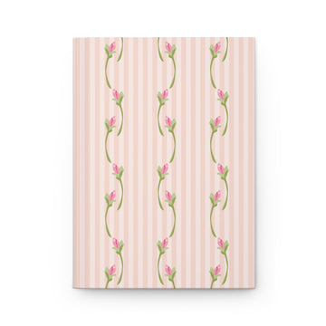 Notebook with floral design on a pink striped background