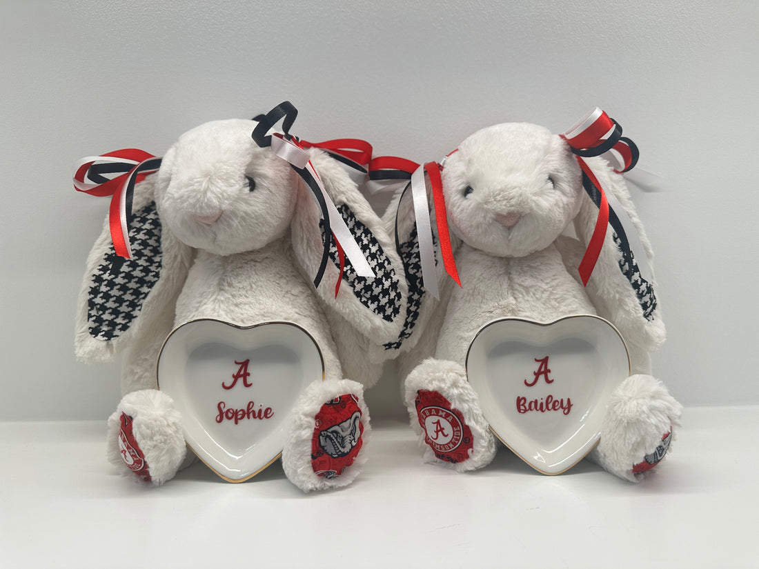 White stuffed bunny with red and black accents and a heart-shaped tray on a white background alabama university
