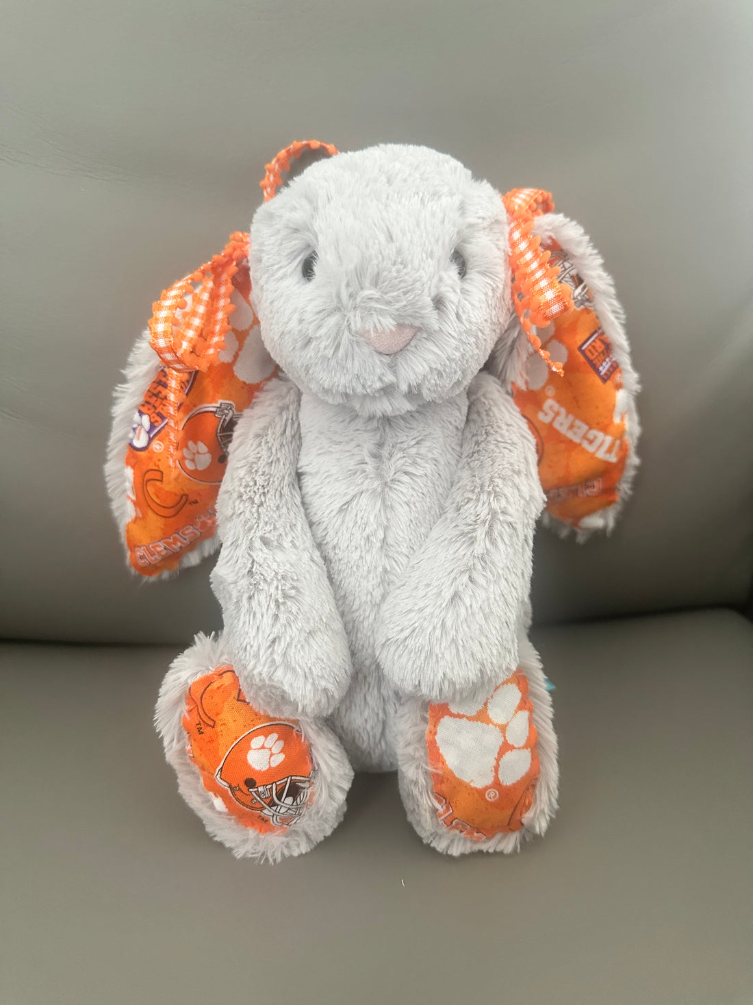 Gray Authentic Jellycat adorned with Clemson fabric and complimentary Orange and White Bows around the ears.