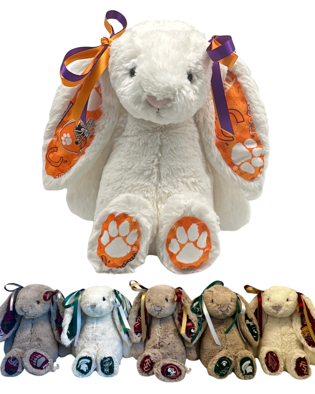 White Clemson University Jellycat bunny with orange and purple ribbons and paw prints, surrounded by smaller plush bunnies with colorful ribbons.