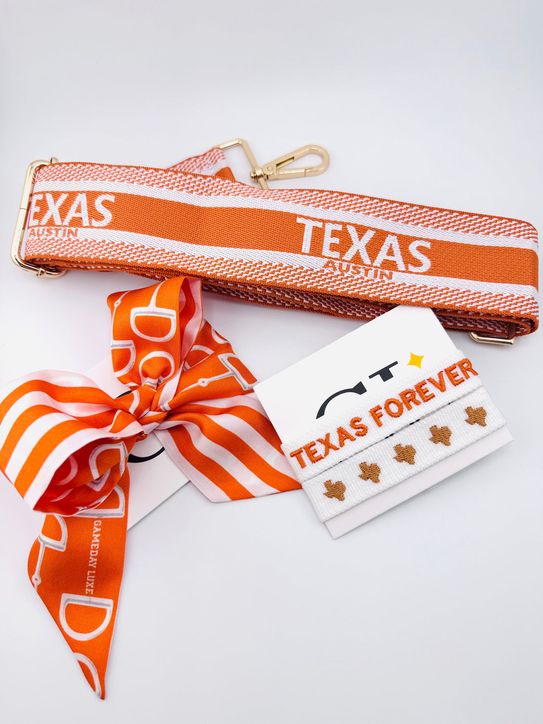 Orange and white striped hair bow with a logo on a white background