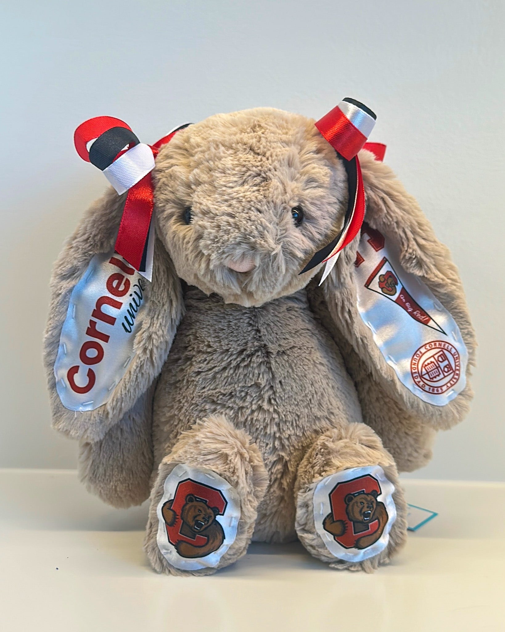 Plush toy elephant with Cornell University branding on a light background