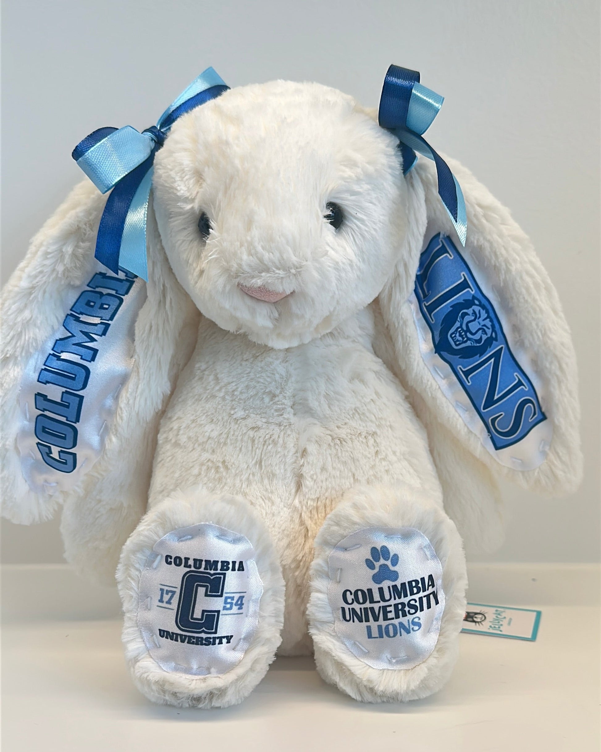 White plush bunny with Columbia University branding on a light gray background