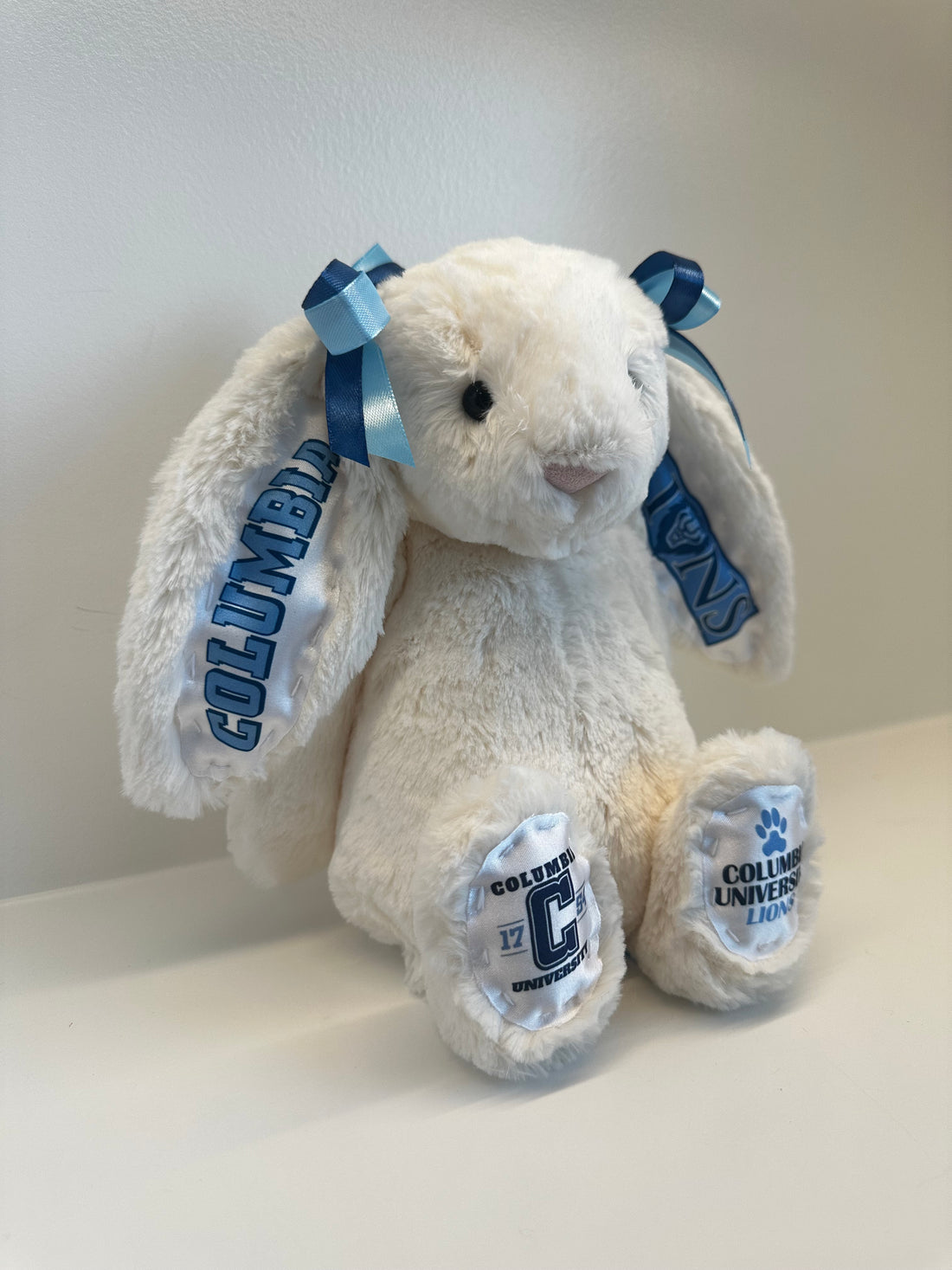 White plush bunny with Columbia University branding on a light gray background