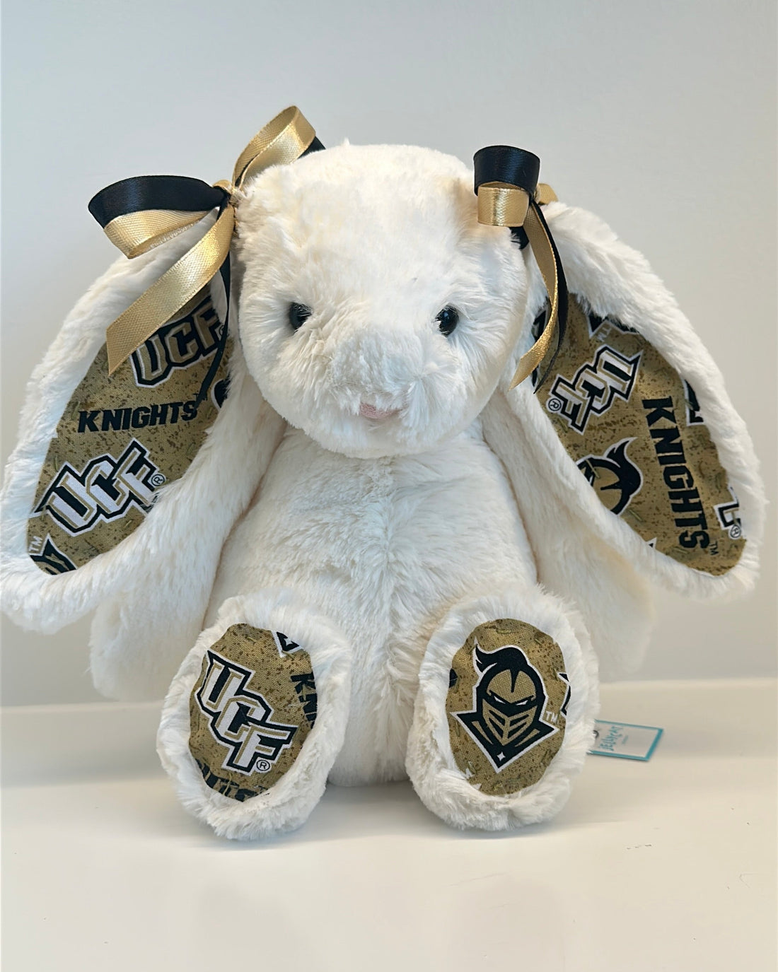 White plush bunny with UCF Knights logo on a white background