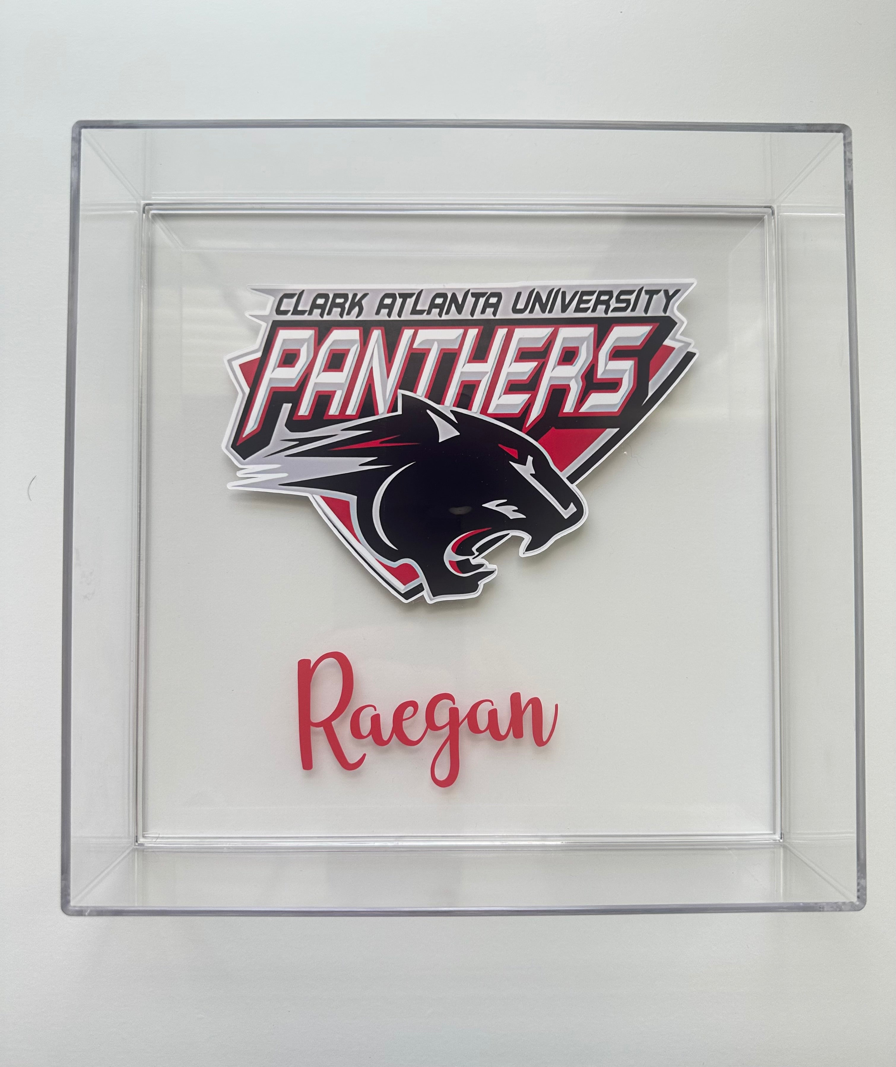 Clark Atlanta University Panthers logo with 'Raegan' text in a clear frame.