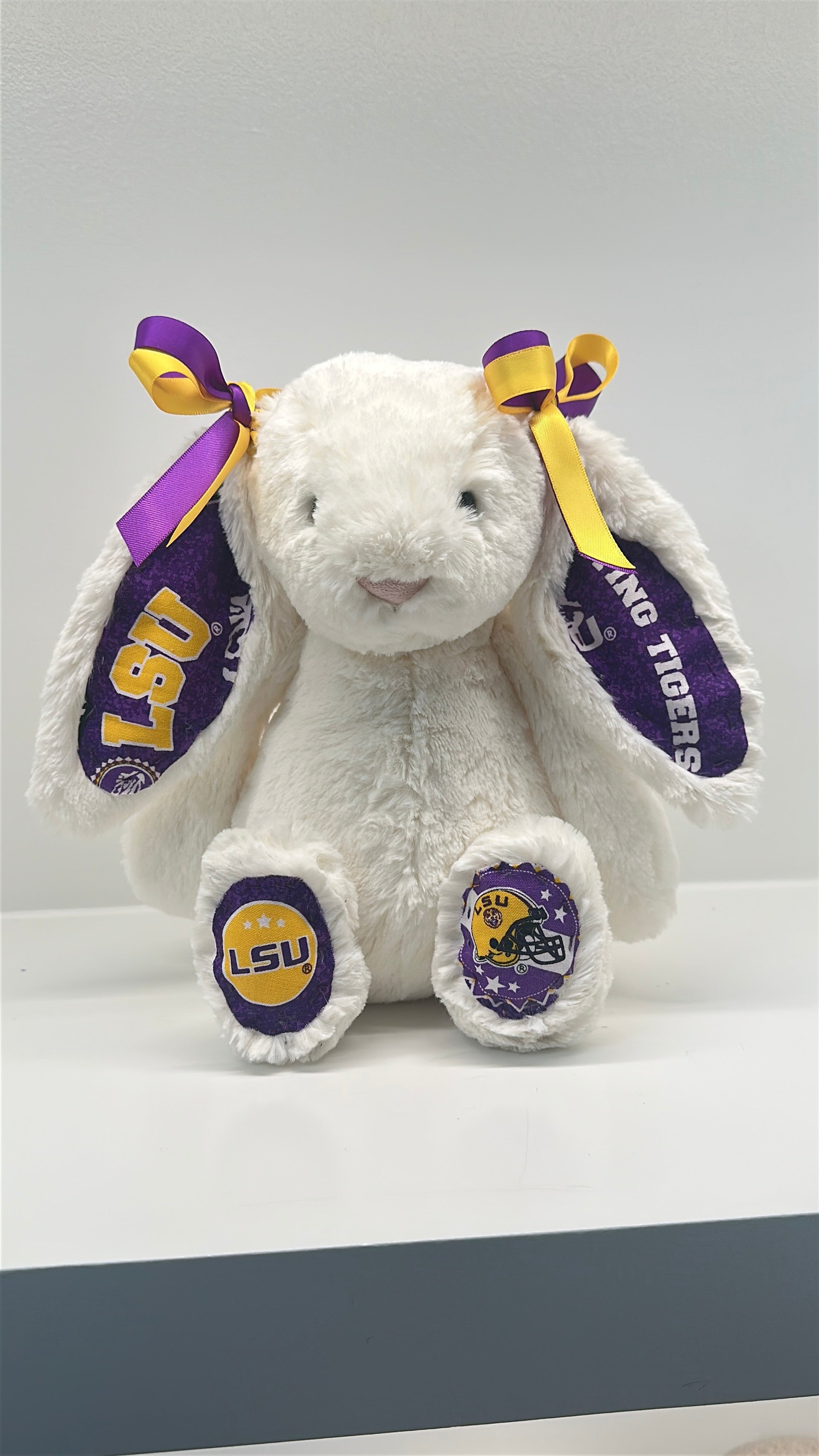 White plush bunny with LSU logos on a white background