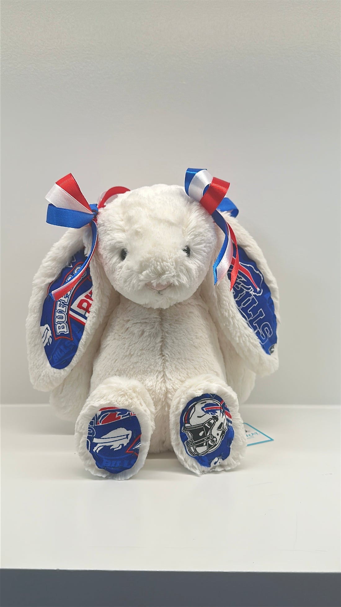 White plush bunny with blue and red bows and LA Dodgers logos on a white background
