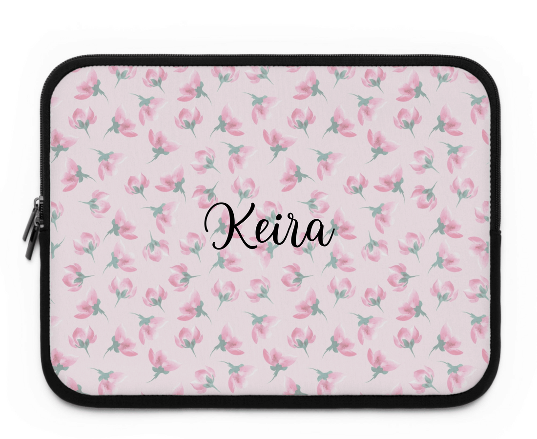Laptop sleeve with pink floral pattern on a white background