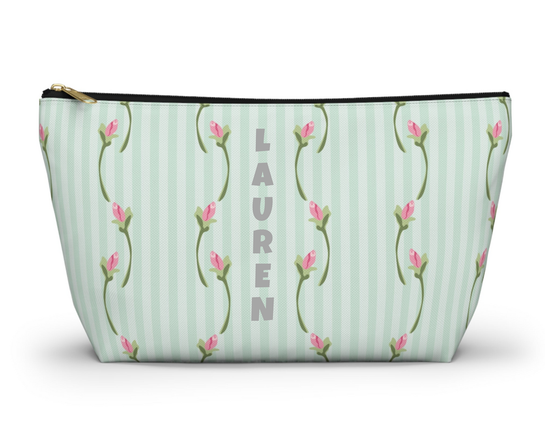 Cosmetic bag with floral pattern on a light green striped background