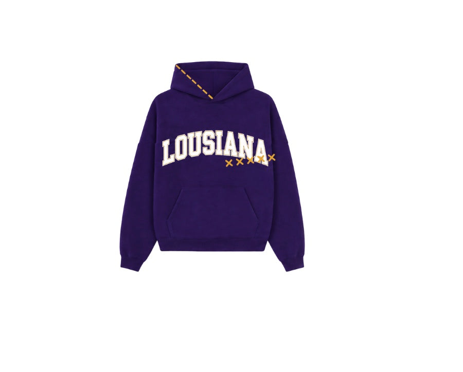 A purple pullover hoodie with 'LOUSIANA' printed in white arched letters across the chest, accented with small orange stars and a dashed orange line detail on the hood.