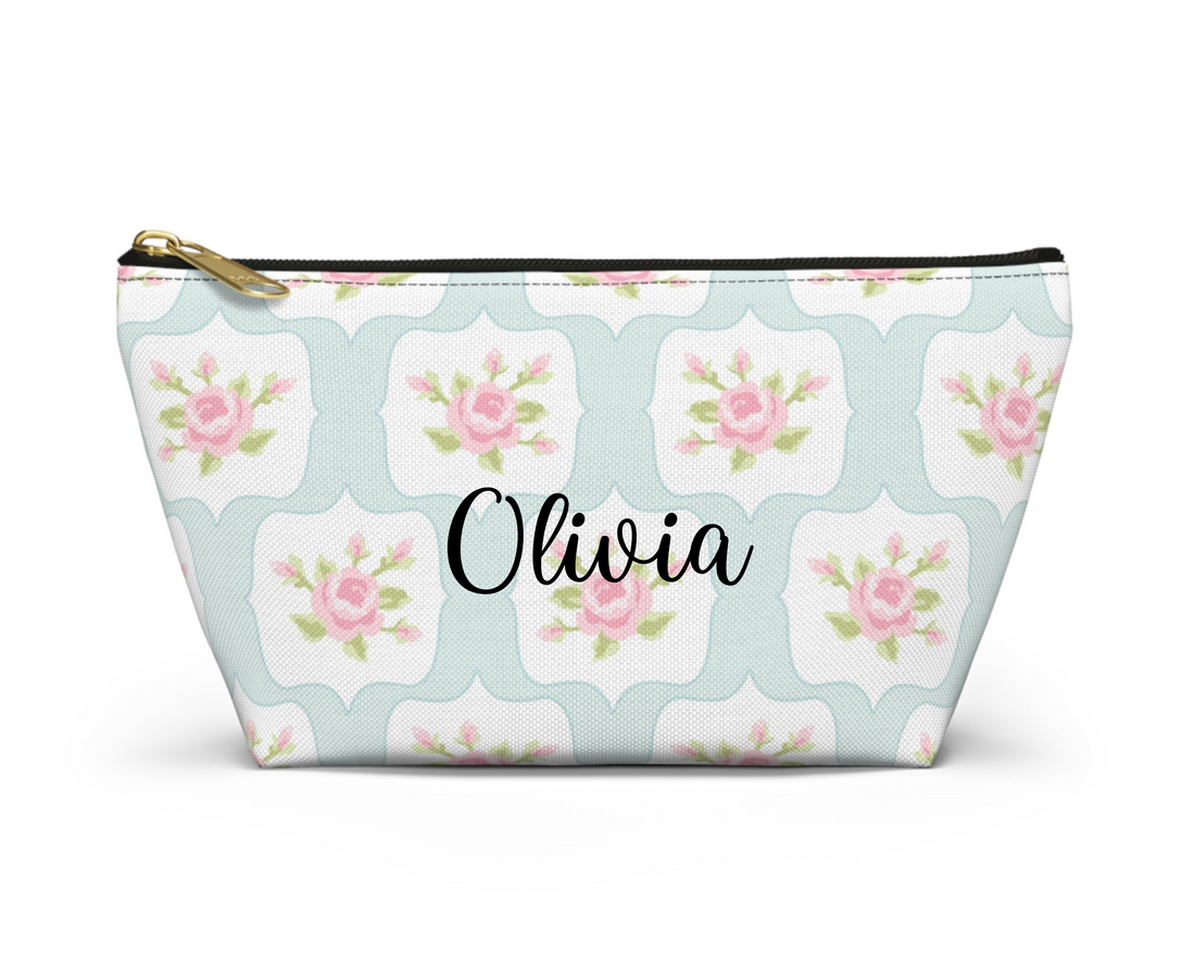 Floral patterned pouch with a gold zipper on a white background