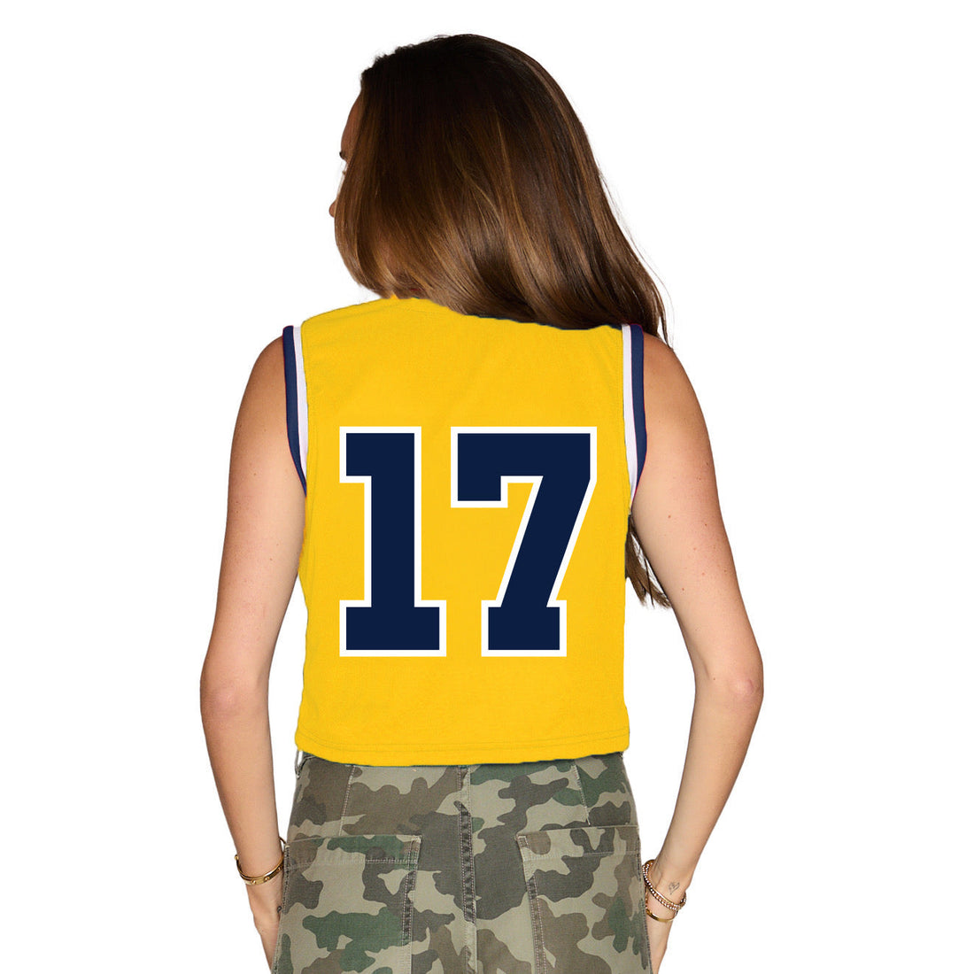 Woman wearing a yellow 'Michigan' tank top with the number 17 on a white background
