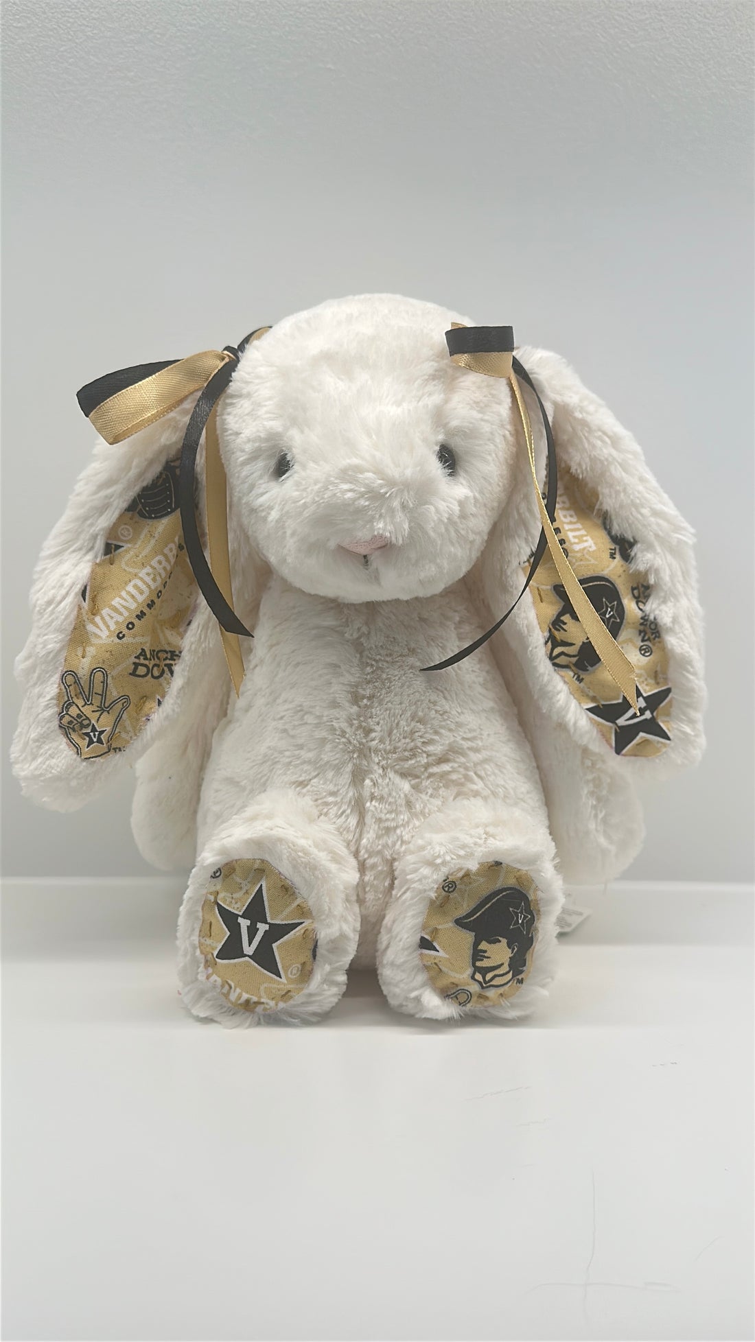 White plush bunny with gold bows and Vanderbilt logos on a white background