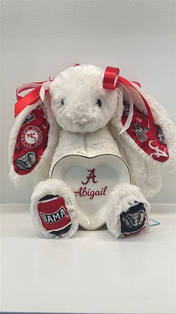 White stuffed bunny with red and black accents and a heart-shaped tray on a white background alabama university