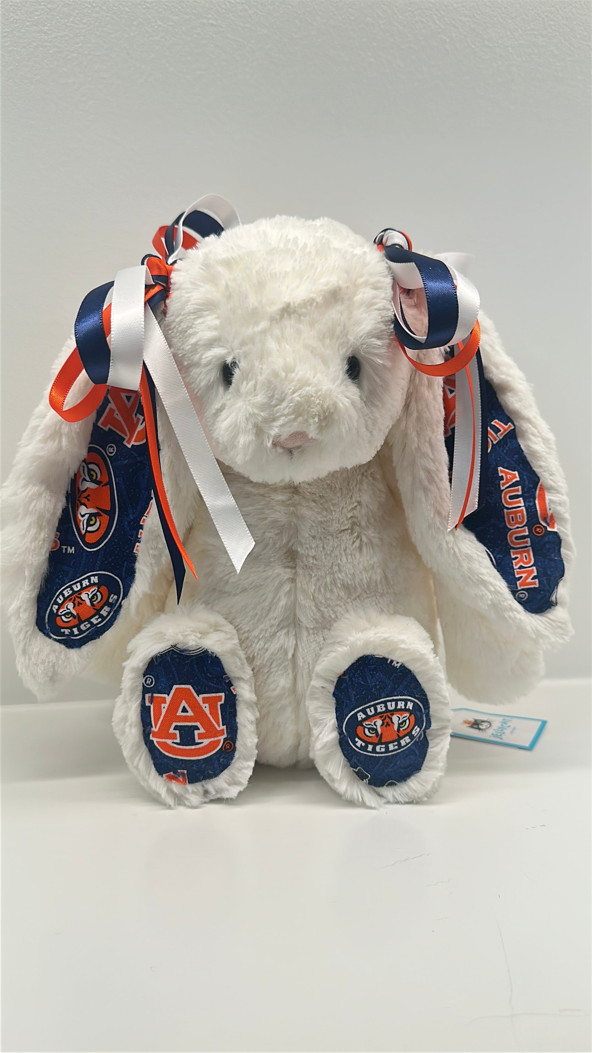 White stuffed animal with Auburn University logos on a white background