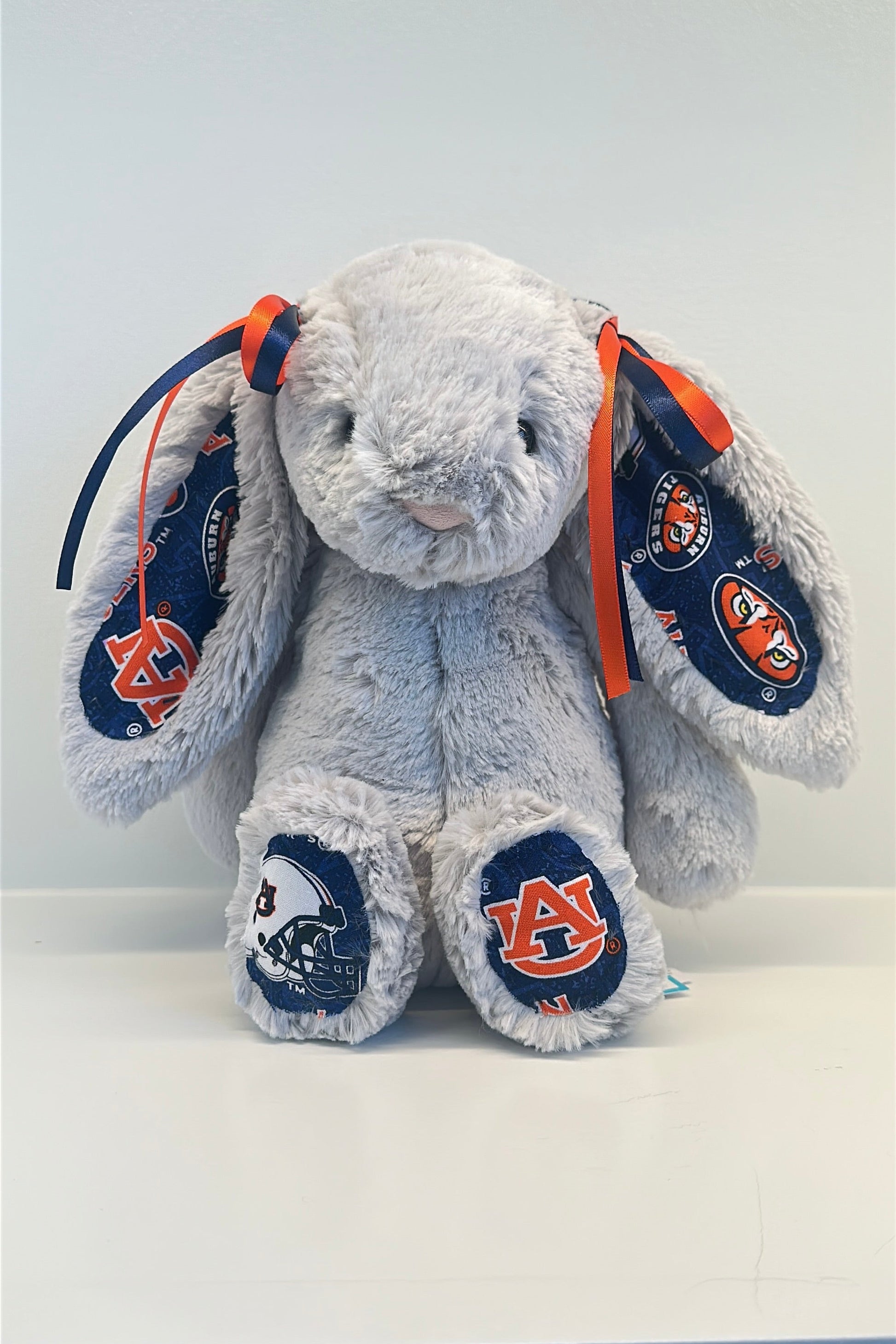 Plush bunny toy with Auburn University logo on a white background