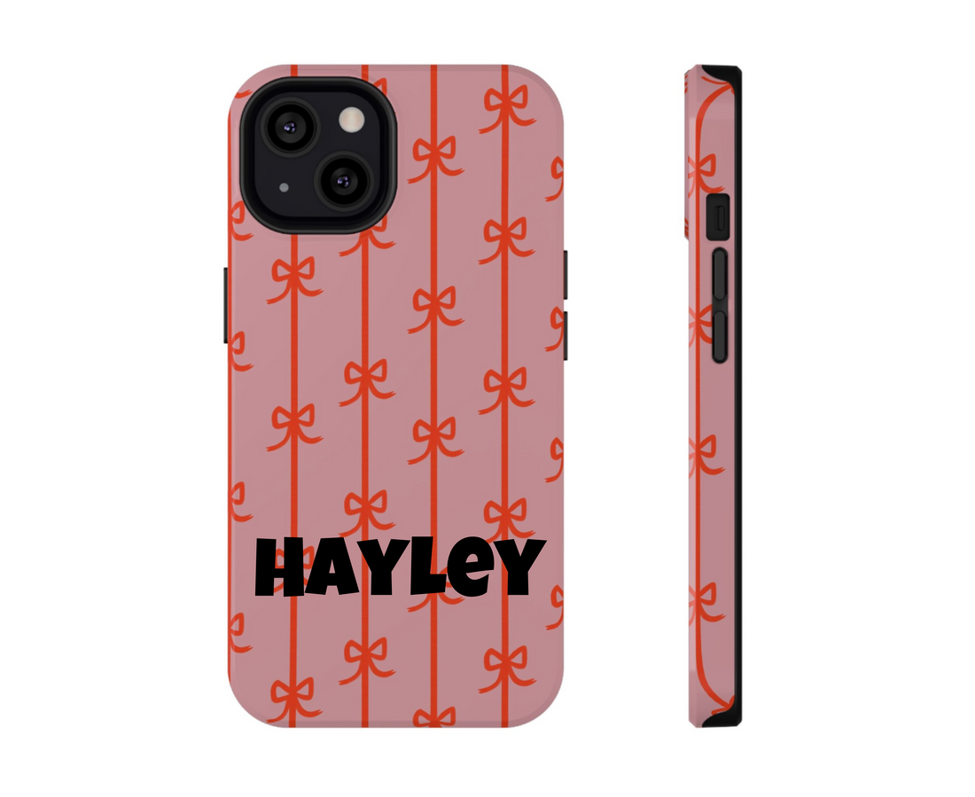 Phone case with red bow pattern on a pink background