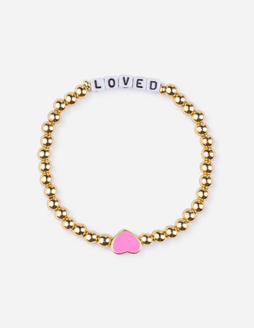 Gold beaded bracelet with a pink heart charm on a white background