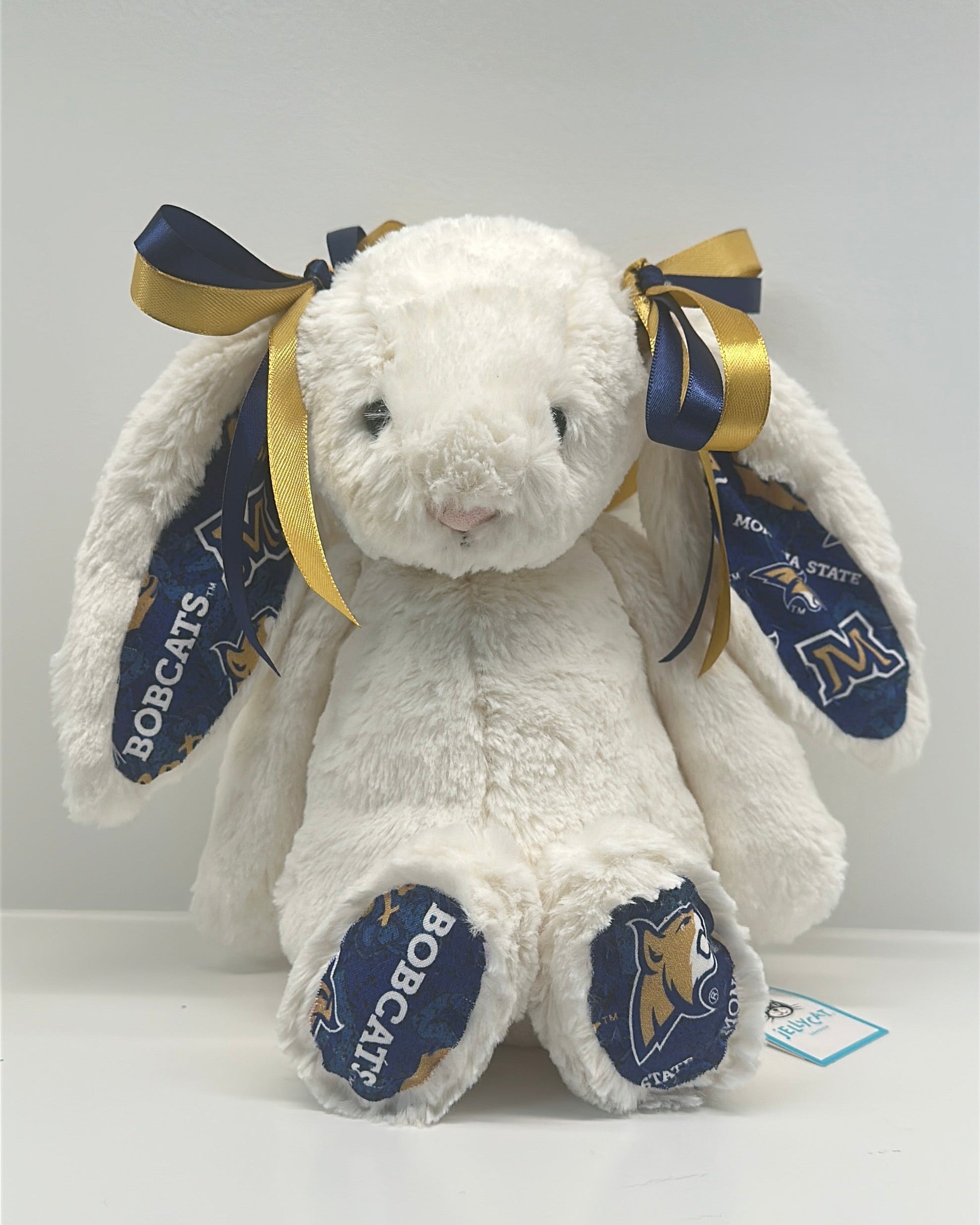 montana state university White plush bunny with blue and gold ribbons on a white background