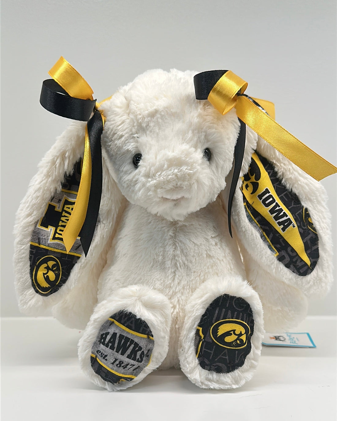White plush bunny with black and gold accents and 'Iowa' branding on a white background university of iowa