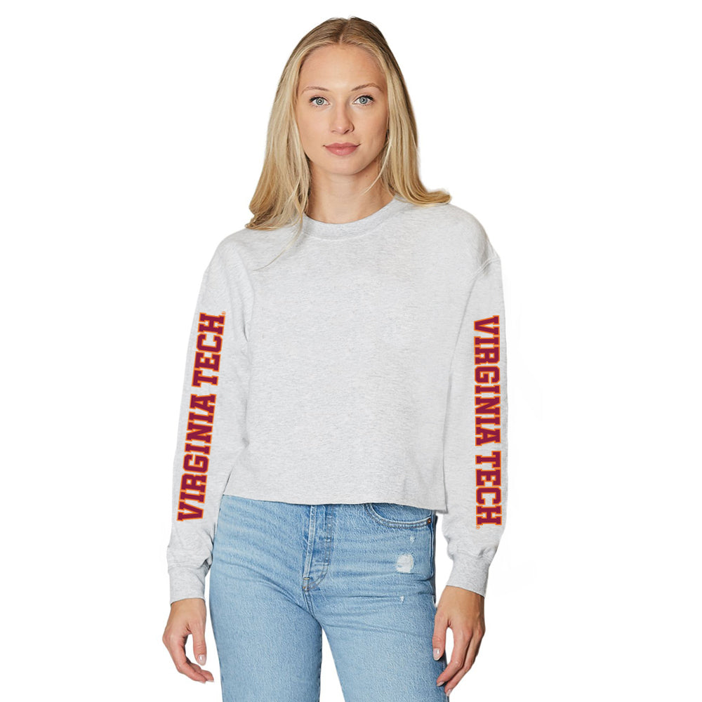 Woman wearing a gray sweatshirt with 'Virginia Tech' text on sleeves against a white background