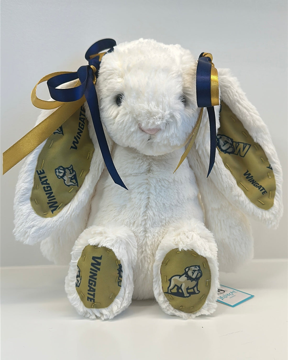 White plush bunny with navy bow and visible wingate university on a white background